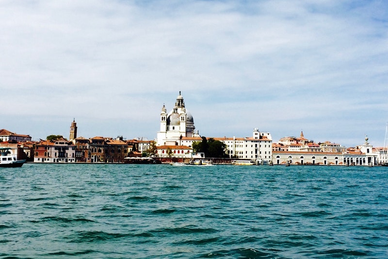 Beautiful image of Venetian skyline with white buildings in the distance.