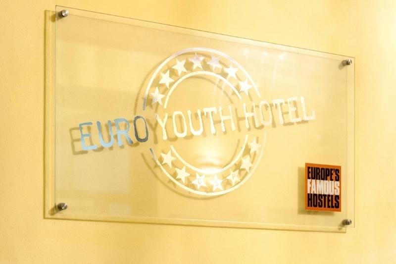 Euro Youth Hostel name on glass plaque on wall.