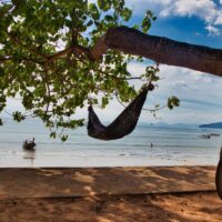 A beach in Krabi with a hammock hanging from a tree